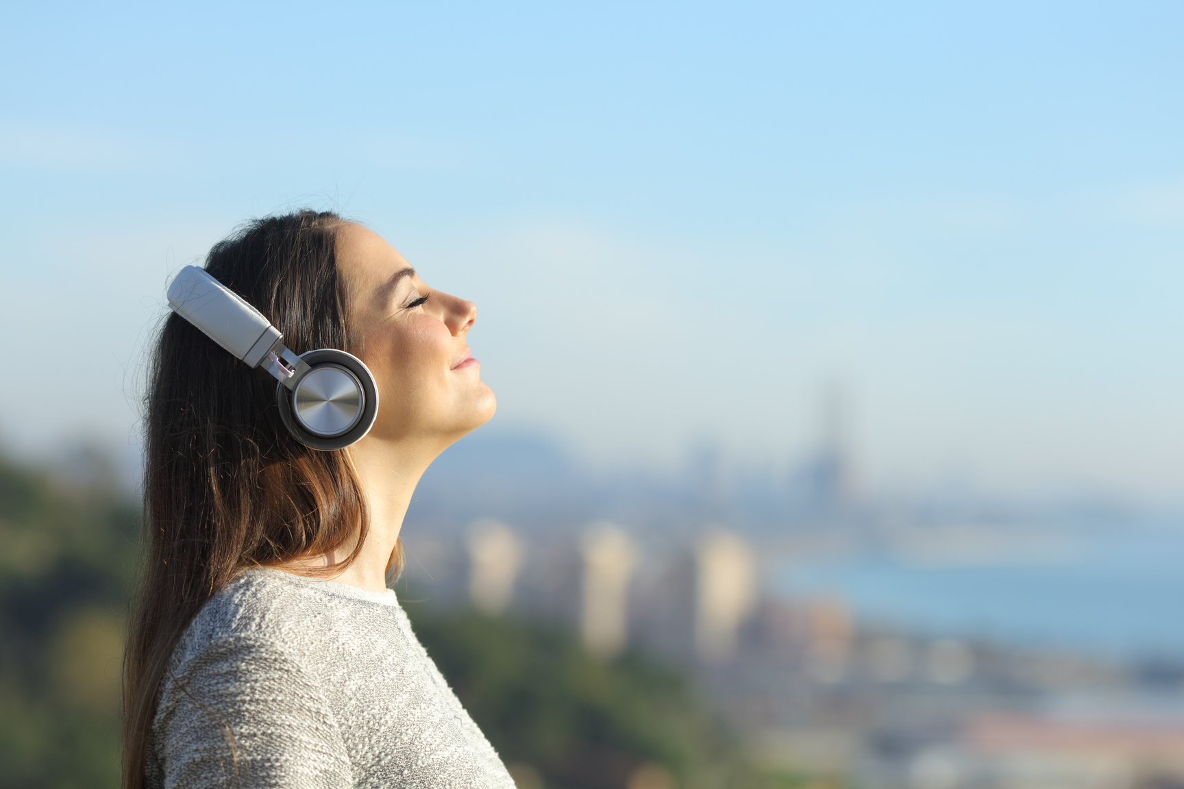 Woman listening to music breathing outdoors